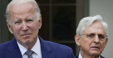 Joe Biden scowls and Merrick Garland looks suspicious
