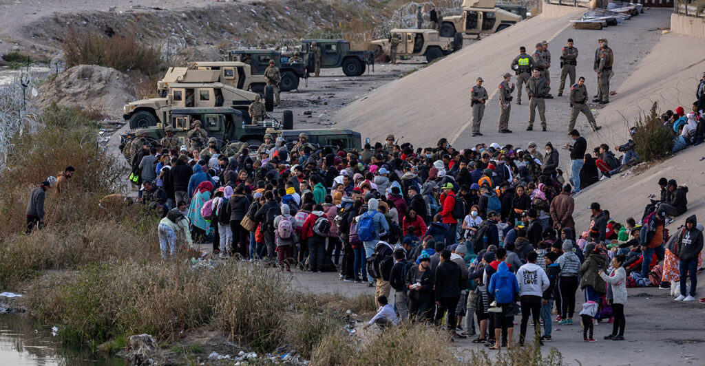 Texas National Guard troops block immigrants from entering a high-traffic border crossing area along Rio Grande in El Paso, Texas