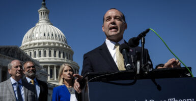 Congressman in a suit in front of the U.S. Capitol