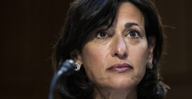 Rochelle Walensky in front of a microphone