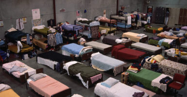 Rows of beds inside a homeless shelter