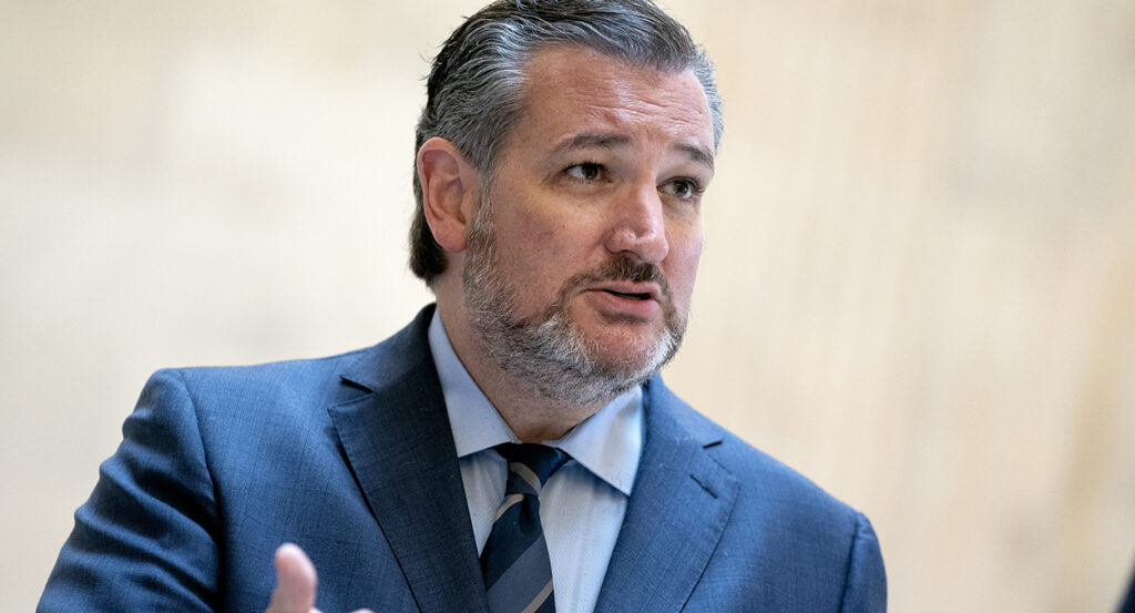 Sen. Ted Cruz gestures while wearing a blue suit
