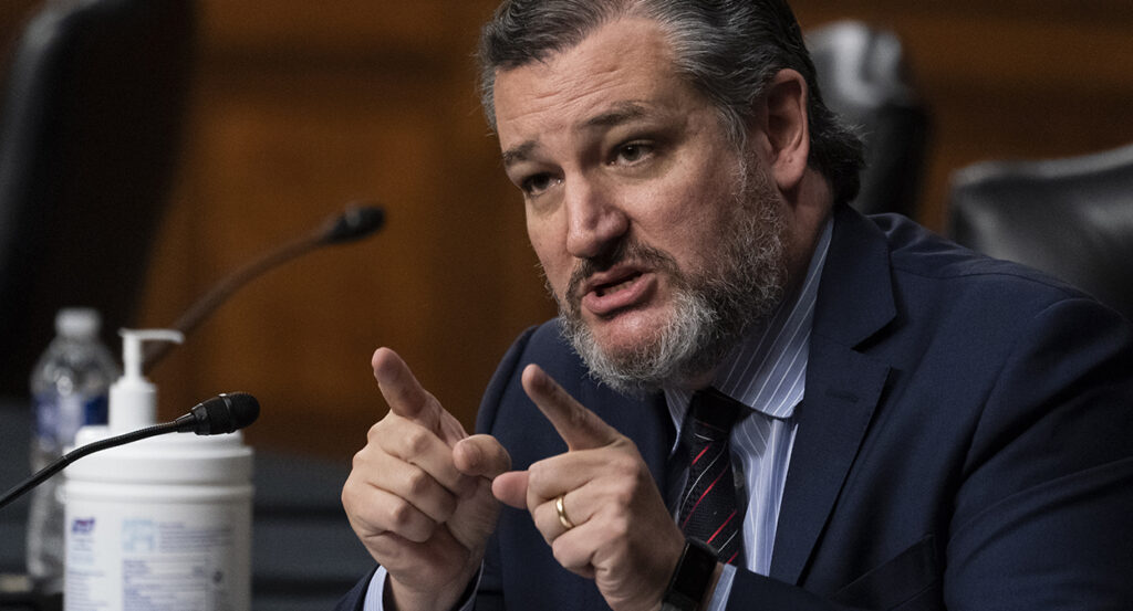 Ted Cruz in a blue suit points while making an argument in the Senate.