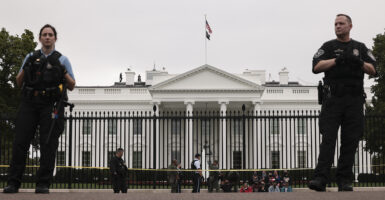 Secret Service stand in front of the White House