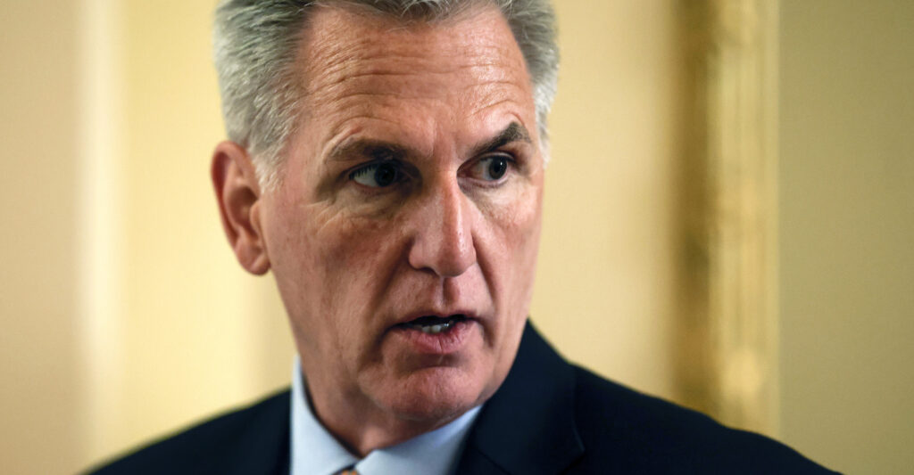 Kevin McCarthy looks to the right in a suit