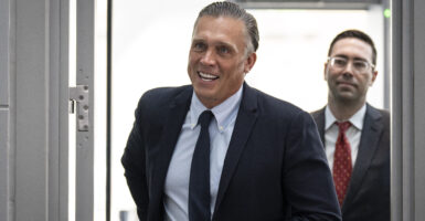 Devon Archer walking through a doorway