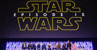 The cast of Star Wars: The Rise of Skywalker beneath a banner reading "Star Wars: Episode IX"