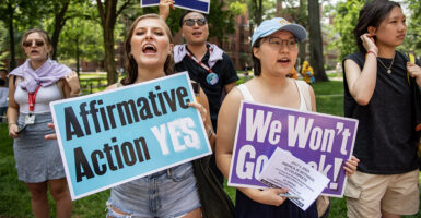 Students hold signs protesting for affirmative action
