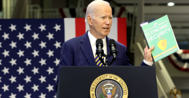 Joe Biden speaking at a podium with the presidential seal
