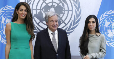 United Nations Secretary-General Antonio Guterres, in a suit, meets with Amal Clooney and Nadia Murad