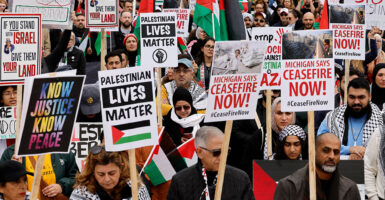 Protesters march with signs reading "Palestinian Lives Matter" and "Michigan Says Ceasefire Now"