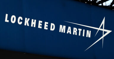 Lockheed Martin, one of the leading global security and aerospace companies in the United States featured a prominent transgender flag in its lobby, according to a photo obtained by The Daily Signal. Pictured: This photograph taken on June 13, 2022, shows the logo from US defence manufacturer Lockheed Martin in Villepinte, a northern suburb of Paris. (Photo: EMMANUEL DUNAND/AFP via Getty Images)