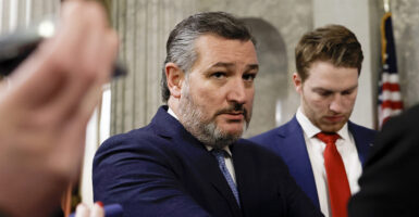 Sen. Ted Cruz stares intently while wearing a blue suit