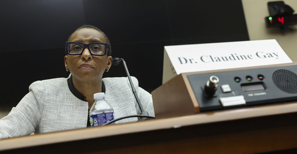 Harvard University President Testifies In House Hearing sitting at witness table