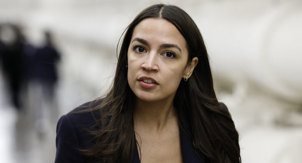 Alexandria Ocasio-Cortez in black in the halls of Congress