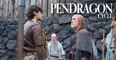 An elderly man with a beard and long hair beneath a bald spot stands in chain mail and armor confronting a young man with black hair in front of a rock wall. Text reading "The Pendragon Cycle" rests above their heads.