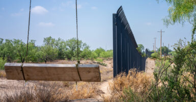 n empty swing overlooks a section of border fencing near the banks of the Rio Grande river in Eagle Pass, Texas.