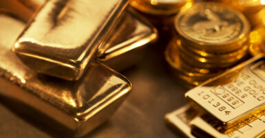 Close up image of assorted gold ingots and gold coins