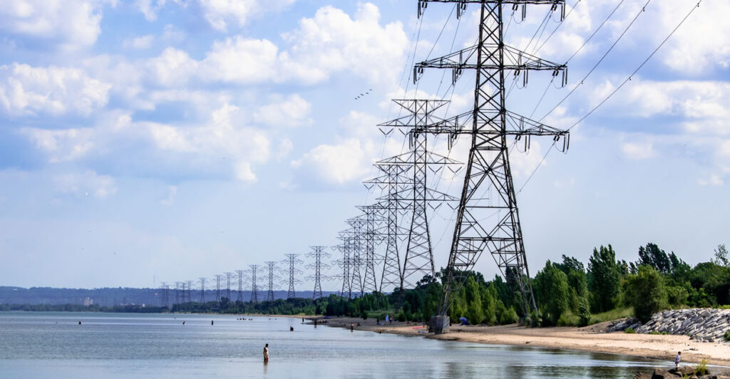 Large power lines stretching along the lake shore