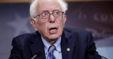 Bernie Sanders at podium in a dark suit and tie
