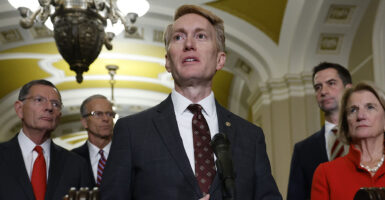 James Lankford in a suit speaks in front of a microphone