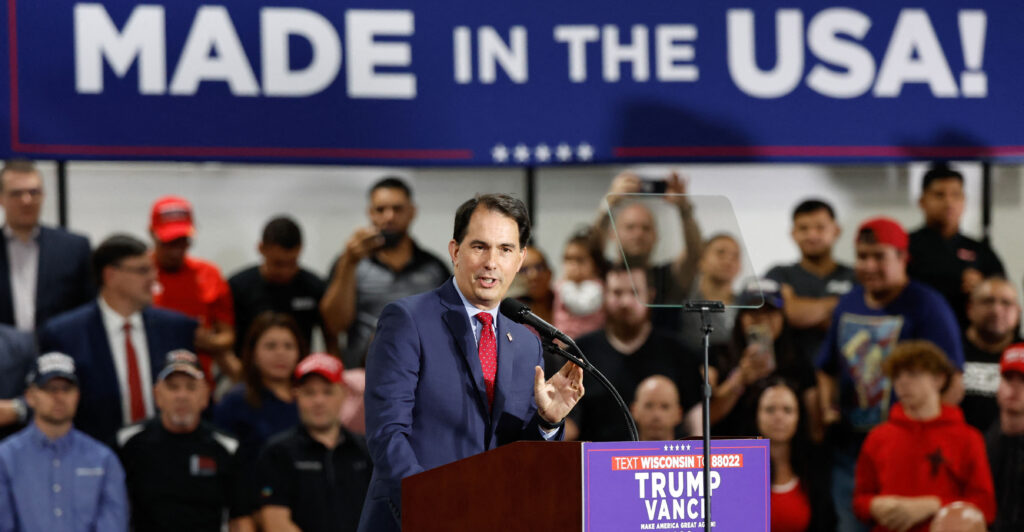 Former Wisconsin Gov. Scott Walker speaks at a campaign rally for then-presidential candidate Donald Trump in Waunakee, Wis., on Oct. 1.