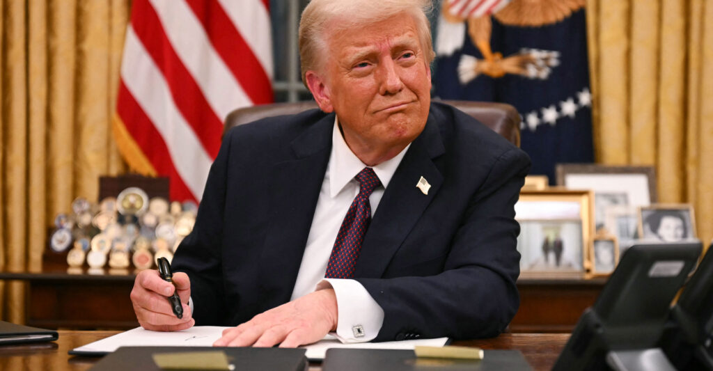 President Donald Trump signs executive orders in the Oval Office.