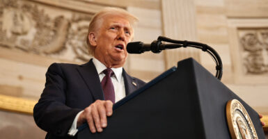 President Donald Trump speaks at a podium.