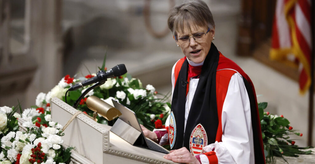 Episcopal Bishop Mariann Edgar Budde in clerical garb at the pulpit