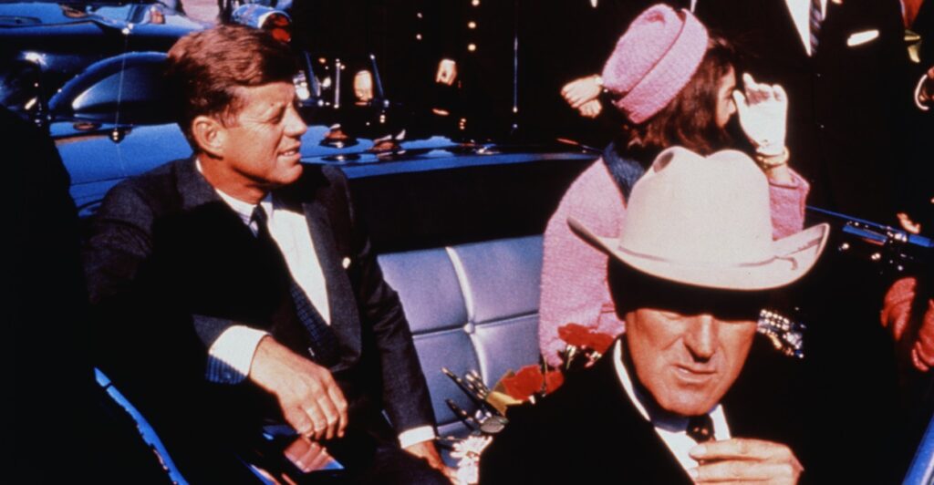 President John F. Kennedy sits in the back seat of a car on the day he was assassinated.