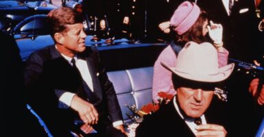 President John F. Kennedy sits in the back seat of a car on the day he was assassinated.