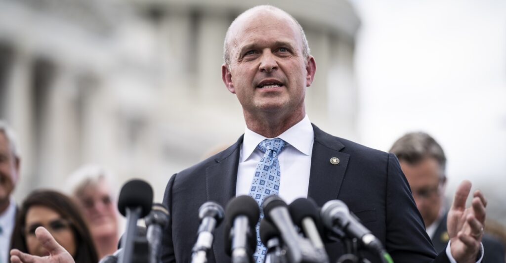 Kevin Roberts, president of Heritage Action for America, stands before microphones as he speaks.