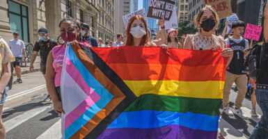 Woman holds LGBTQ flag