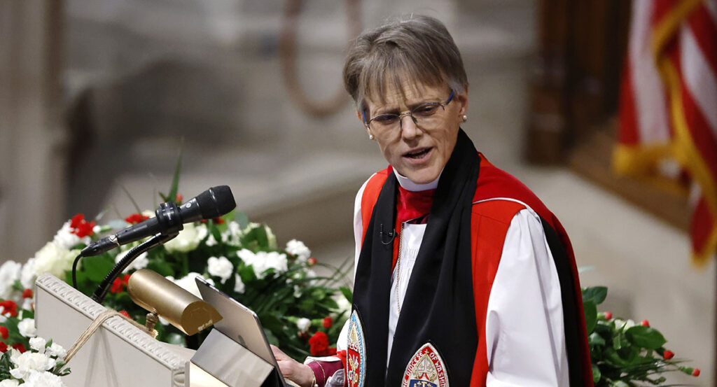 Episcopal Bishop Mariann Budde in red and black robes scowls
