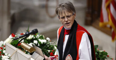 Episcopal Bishop Mariann Budde in red and black robes scowls