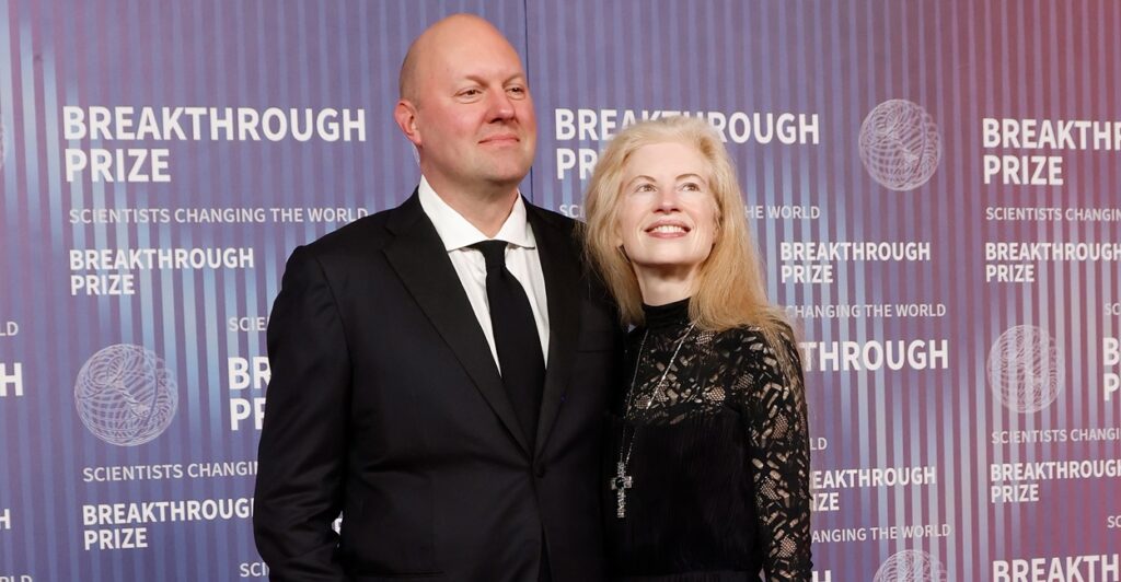 Marc Andreessen stands next to his wife with his hands by his side at an awards ceremony.