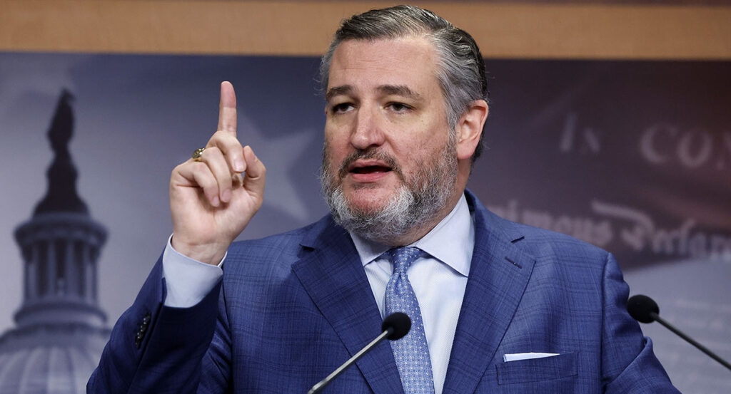 Sen. Ted Cruz raises his finger in a blue suit