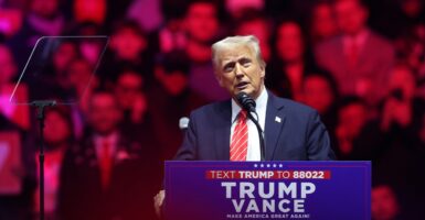 Donald Trump stands at a podium and speaks.