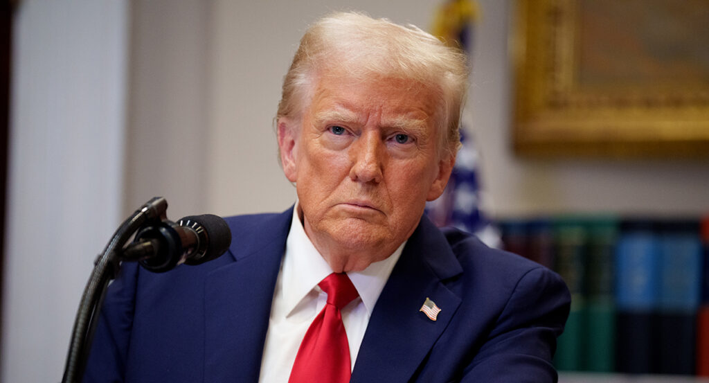 Donald Trump in a blue suit looks skeptical