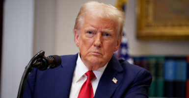 Donald Trump in a blue suit looks skeptical