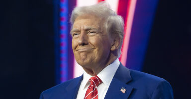 Donald Trump smiles in a blue suit