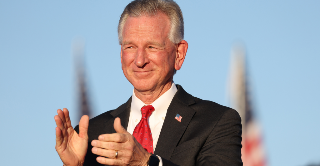 Sen. Tommy Tuberville, R-Ala., applauds at a campaign rally.