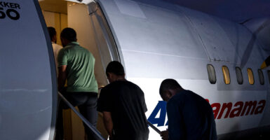 Colombian citizens board a chartered flight as they are deported from Panama City, Panama, to which they had illegally immigrated.