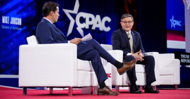 House Speaker Mike Johnson, R-La., right, chats with interviewer Rob Finnerty at the Conservative Political Action Conference on Thursday.