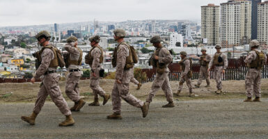 Border Patrol agents in military fatigues