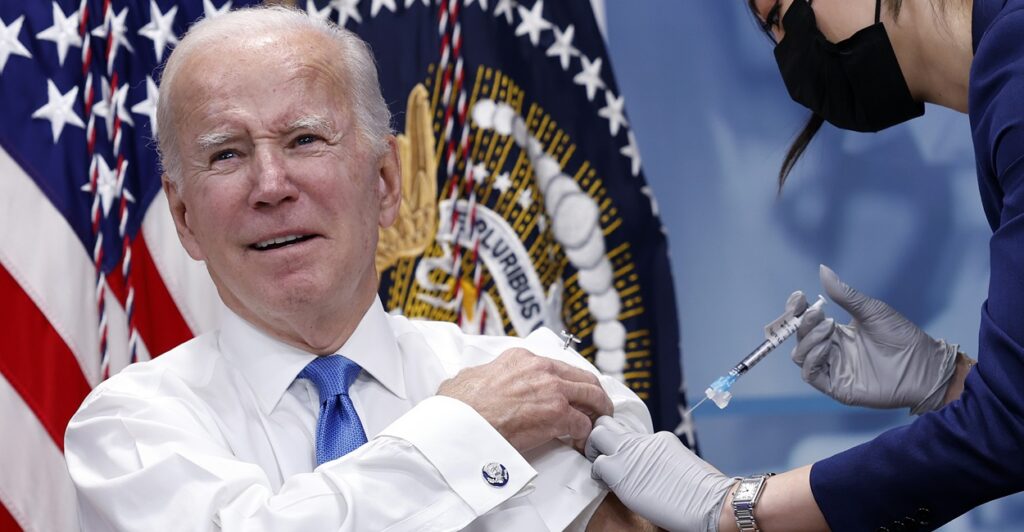 Joe Biden grimaces as he gets a shot of the COVID-19 vaccine.