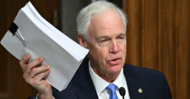 Sen. Ron Johnson, R-Wis., holding a ream of paper