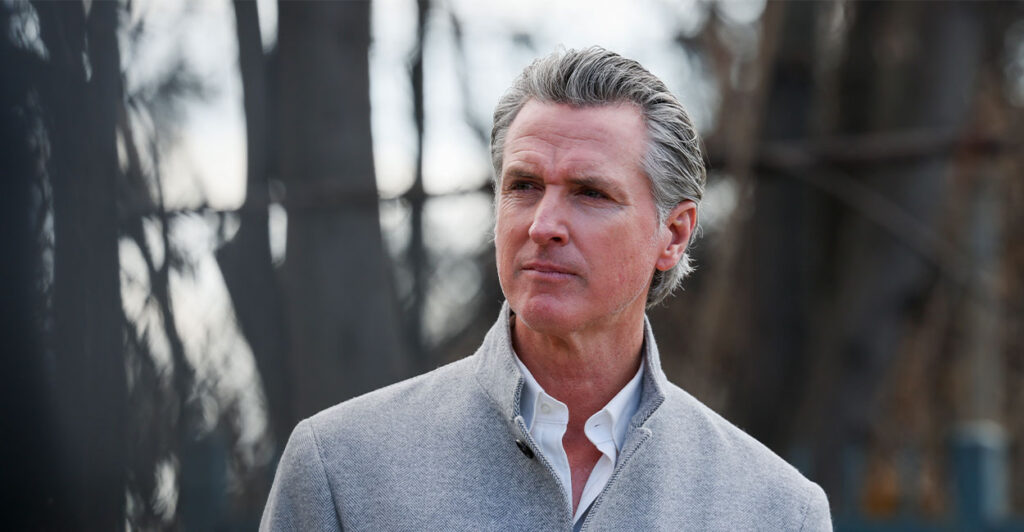 Governor Gavin Newsom standing in front of a blurry background.