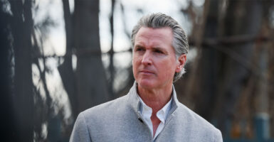 Governor Gavin Newsom standing in front of a blurry background.