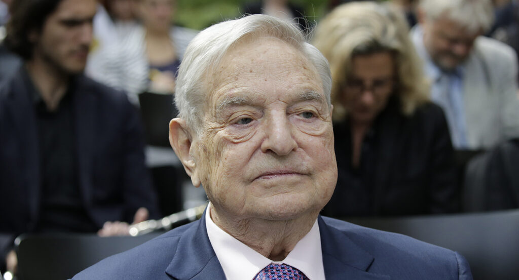 George Soros in a blue suit